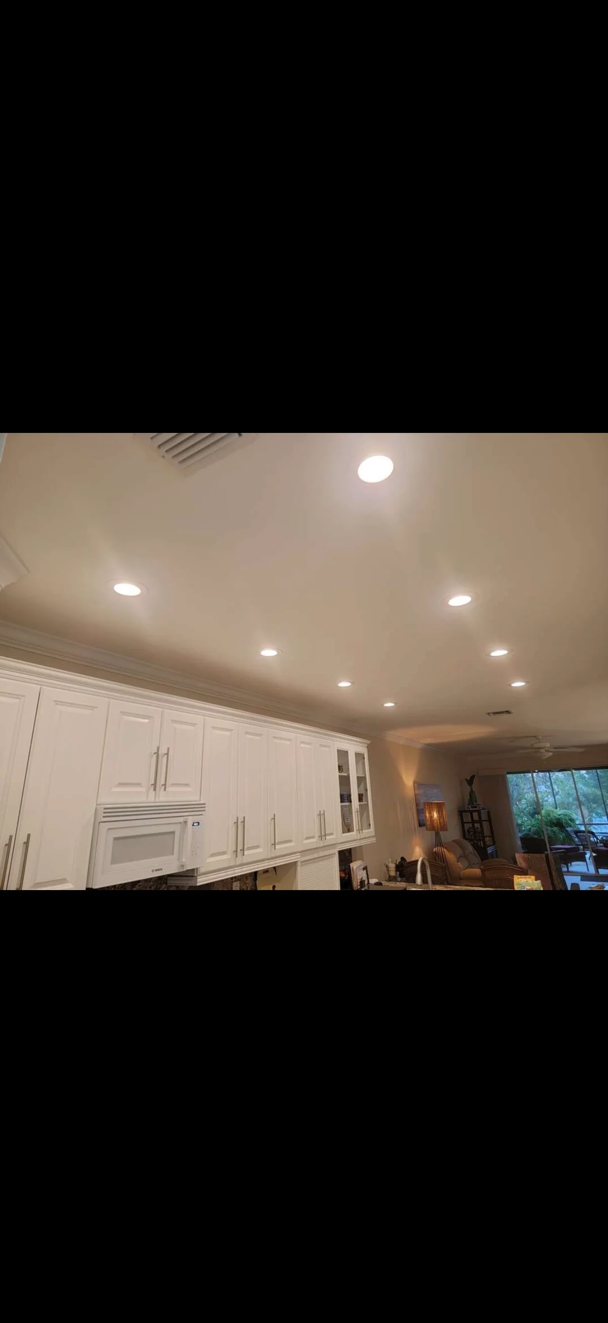 Recessed kitchen lighting. Evenly spaced recessed lights across the kitchen and living area.