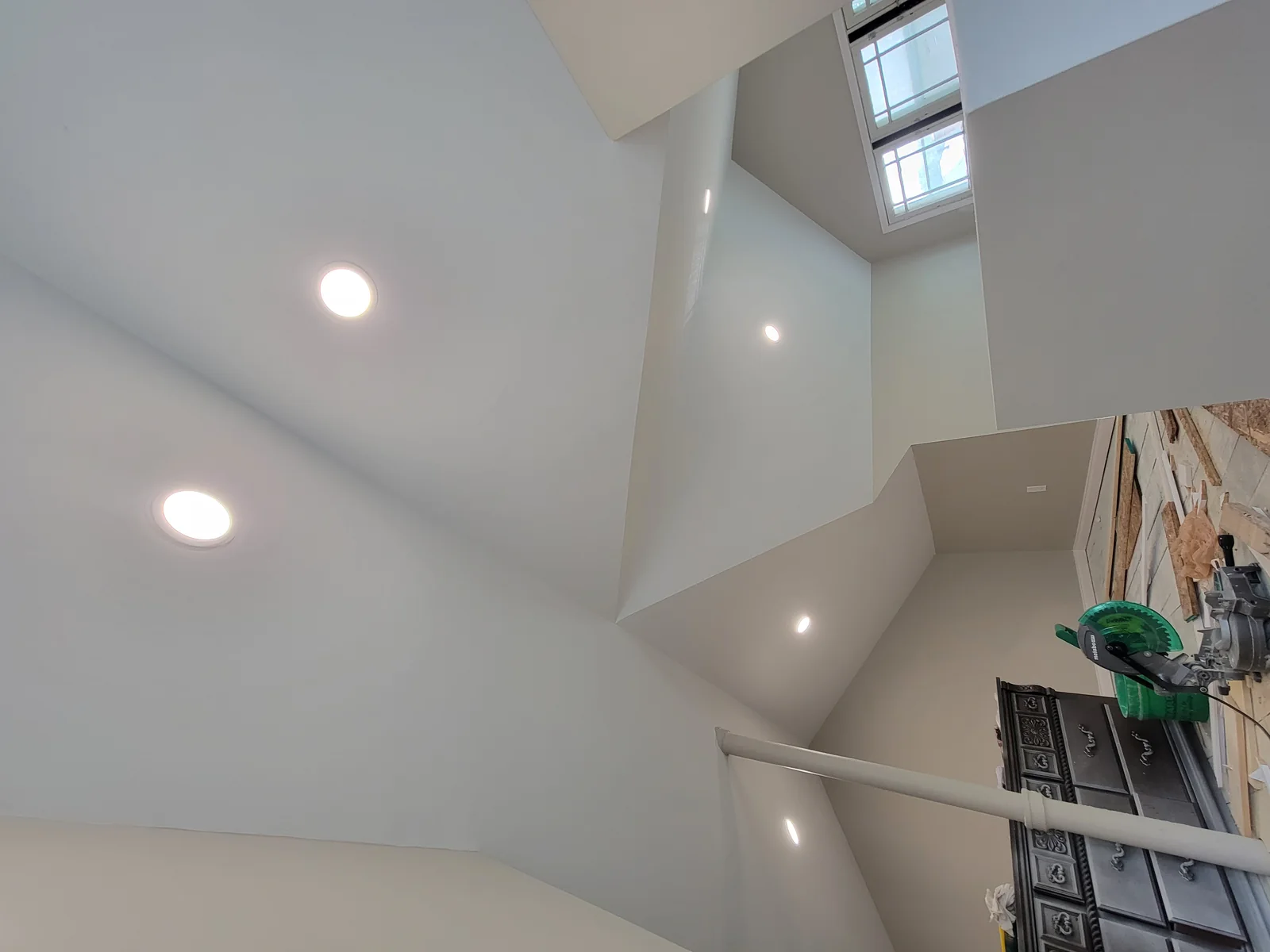 Lighting a vaulted room. Recessed fixtures installed across an angled ceiling.