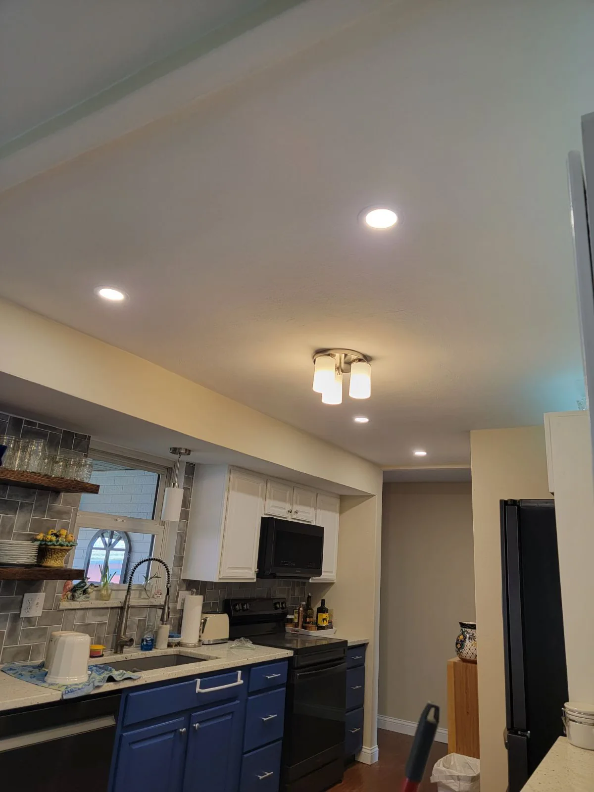 Kitchen lighting update. Recessed lights alongside an existing ceiling fixture.