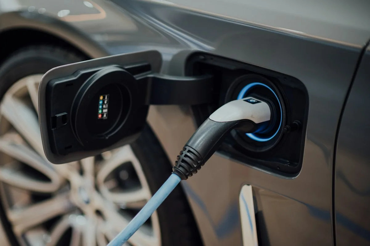 Illustrative electric vehicle connected to a charging cable